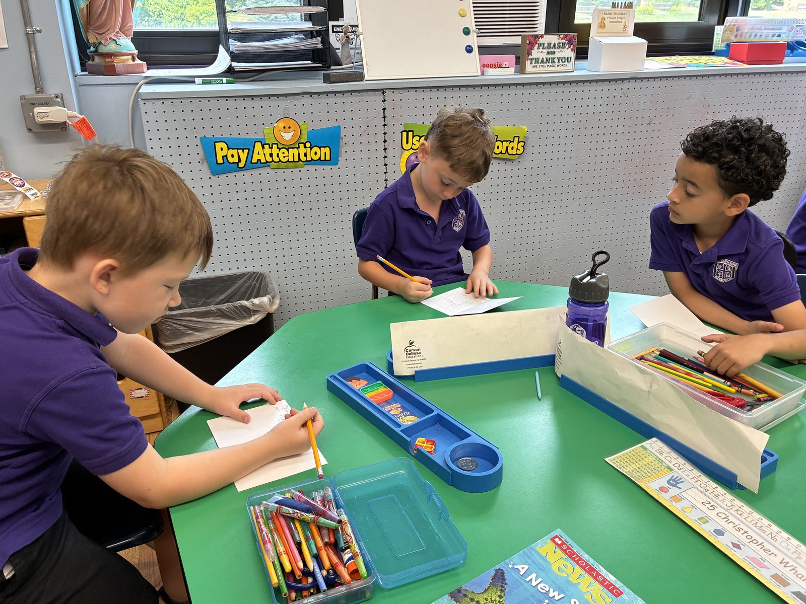 Scholarship students working together at a table in a diocesan school